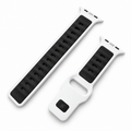 Apple Watch band Pulse Polar White by Suritt in white and black FKM, laid flat with a gold Apple Watch.